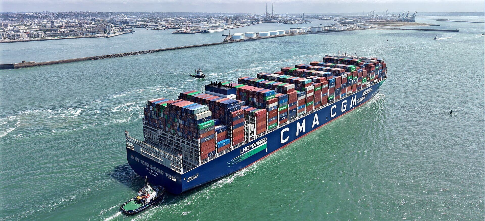 Loaded container ship leaving port, seen from above